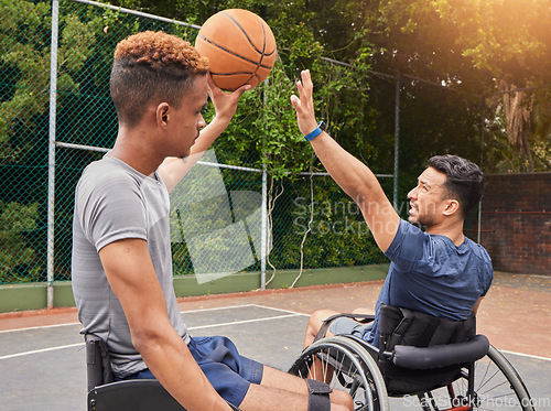 Image of Wheelchair, basketball and men friends with ball at court outdoor for fitness, sports and performance match. Exercise, mobility and man with disability and personal trainer for recovery motivation