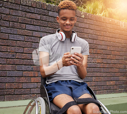 Image of Phone, wheelchair and outdoor man with disability typing internet, web or online search for fitness training information. Cellphone communication, reading and African person post to social media app