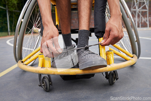 Image of Fitness, wheelchair and man tie shoes ready for training, exercise and workout on outdoor court. Sports, start and male person with disability tying sneakers for performance, wellness and challenge