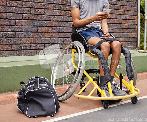 Image of Sports, wheelchair basketball and a man with a disability on a court for fitness, training or competition. Phone, legs and exercise with a male athlete outdoor for a workout as a game player