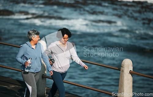 Image of Fitness, exercise and senior women by ocean for healthy body, wellness and cardio on promenade. Sports, friends and female people with water bottle on boardwalk for walking, training and workout