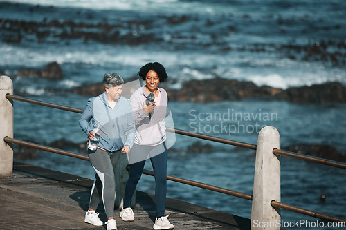 Image of Fitness, walking and woman and senior mother by ocean for healthy body, wellness and cardio on promenade. Sports, happy and female people on boardwalk for exercise, marathon training and workout