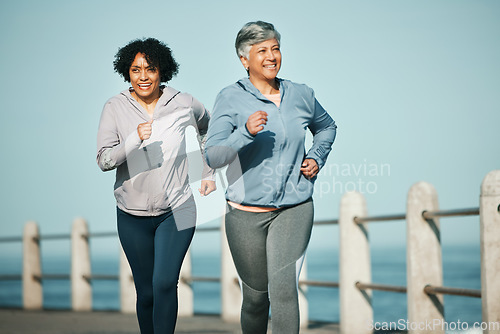 Image of Fitness, running and senior women at beach for health, wellness and exercise in nature together. Elderly, friends and ladies at sea happy, workout and active retirement, fun and bonding ocean run