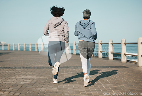 Image of Back view, beach and friends running for fitness together as morning exercise for wellness and outdoor bonding. Health, endurance and people training for marathon in Cape Town for sports workout