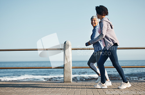 Image of Women, beach and friends running for fitness together as morning exercise for wellness and outdoor bonding. Health, endurance and people training for marathon in Cape Town for sports workout