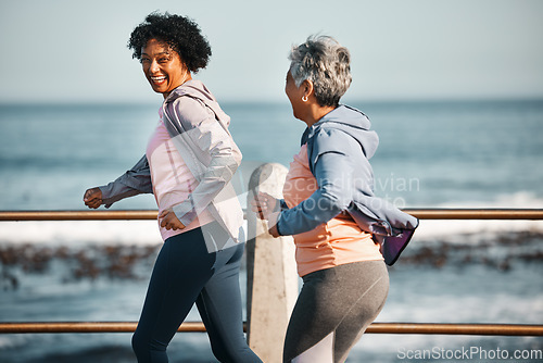 Image of Fitness, running and senior women by ocean for healthy lifestyle, wellness and cardio on promenade. Sports, friends and happy female people walking on boardwalk for exercise, training and workout
