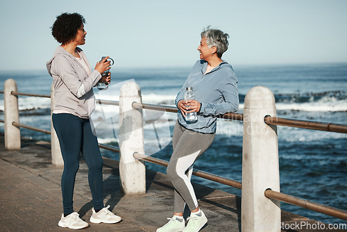 Image of Fitness, walking and senior women relax by ocean for healthy lifestyle, wellness and cardio on promenade. Sports, friends and female people talking on boardwalk for exercise, training and workout