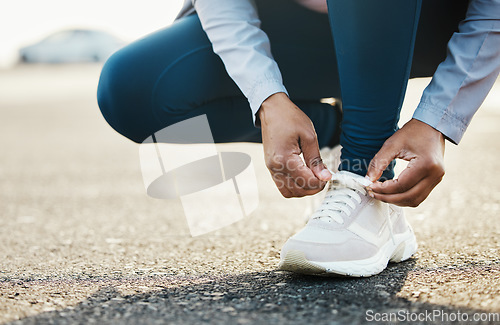 Image of Sports, closeup and woman tie shoes outdoor in the road for running workout in the city. Fitness, health and zoom of female athlete tying her laces for cardio exercise for race or marathon training.