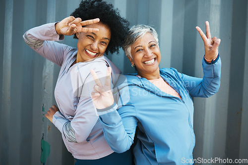 Image of Fitness, portrait and senior friends with peace sign bonding and posing after workout or exercise together. Happy, fitness and elderly female athletes with hipster hand gesture after training by wall