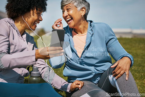 Image of Music, fitness and senior friends laughing on the grass outdoor taking a break from their workout routine. Exercise, training and funny with elderly people streaming audio on a field for wellness