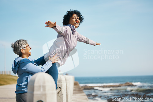 Image of Beach, love and senior mother with woman doing airplane gesture playing, crazy and funny with parent for outdoor exercise. Health, wellness and goofy women bonding by the sea or ocean for workout