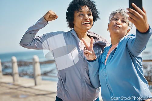 Image of Mature women, friends and outdoor for peace selfie with fitness, motivation and travel memory. Profile picture, social media and influencer people with smile, adventure and flex arm for strong power