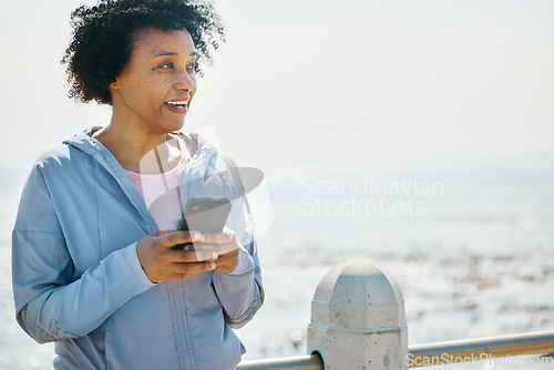 Image of Running, phone and fitness with black woman at beach for relax, workout and social media. Network, communication and contact with female runner training in nature for technology, sports or mobile app