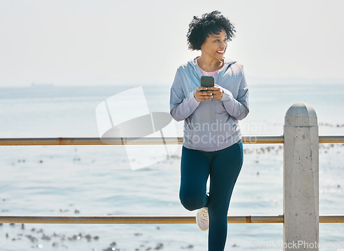 Image of Happy, phone and fitness with black woman at beach for running, workout and mockup. Network, communication and contact with female runner training in nature for technology, sports and mobile