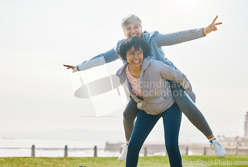 Image of Beach, funny and senior friends piggyback together doing airplane gesture playing, crazy and laughing at outdoor exercise. Health, wellness and goofy elderly women bonding by the sea for workout