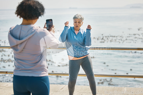 Image of Senior woman, dancing and influencer outdoor for fitness, fun energy and celebrate retirement. Exercise, mature and funny people at sea for happy photograph, adventure or social media travel memory