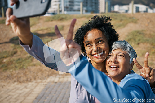 Image of Friends, mature women and outdoor for peace selfie at a park with motivation and travel memory. Profile picture, social media and influencer people with hands, adventure and happy emoji in Chicago