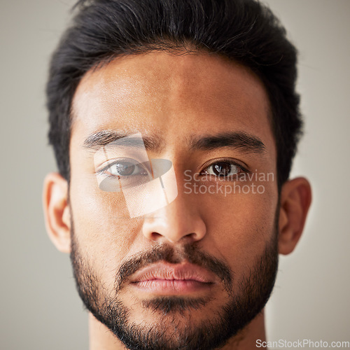 Image of Face, portrait and serious asian man in studio with focus, wellness and awareness. Headshot of a young male model isolated on a grey background with concentration, vision and stern expression