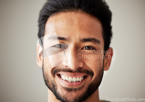 Image of Face, portrait and smile of happy asian man in studio with positive mindset, wellness and awareness. Face of a young male model isolated on a grey background with happiness and confident headshot