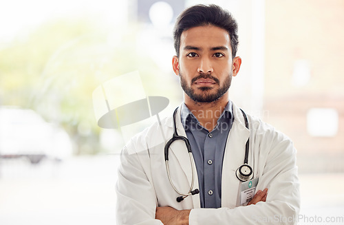 Image of Arms crossed, serious and man doctor portrait in hospital with stethoscope, attitude and determined mindset. Proud, face and Japanese health expert worker in a clinic for help, advice and service