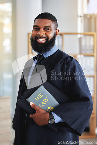 Image of Happy, man and portrait with a book on the law, rules or research on legal constitution, regulation or policy from government. African businessman, lawyer or attorney with knowledge of justice