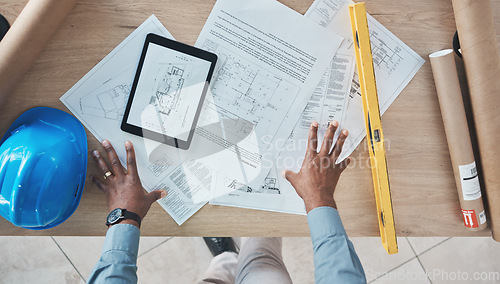 Image of Architecture, person hands and blueprint planning, construction design and renovation on desk above. Engineering paper, floor plan and project management sketch or drawing tools on digital technology