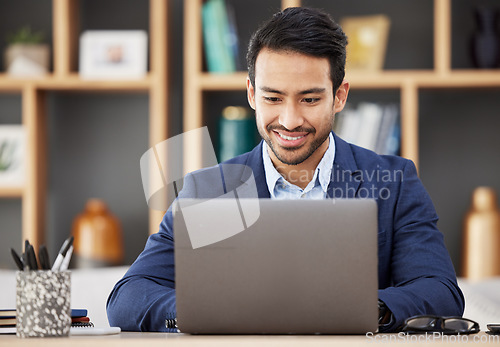 Image of Man in office with laptop, smile and typing email, proposal or writing online report networking at startup. Happy businessman, computer and administration work for editing, copywriting or web search.