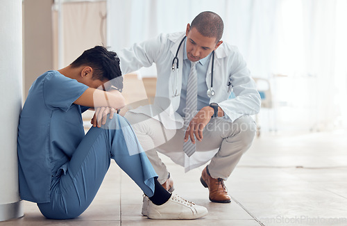 Image of Sad nurse on floor and doctor support, helping or empathy for healthcare fail, mental health and stress or anxiety. Tired, fatigue and mentor or medical people with depression in hospital or clinic