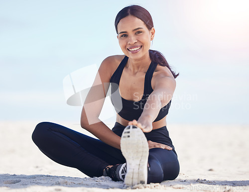 Image of Portrait, beach and woman stretching feet happy in nature for running, workout or body, exercise or wellness. Shoes, stretch and face of female runner smile at sea for training, sports or fitness