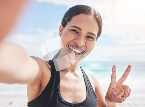 Image of Fitness, selfie and woman at beach with peace hands for running, sports or exercise in nature. Portrait, happy and lady health and wellness influencer smile for social media, blog or profile picture