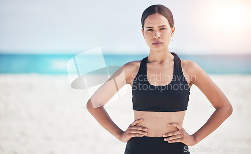 Image of Portrait, fitness and serious woman at a beach for training, sports and exercise, running and workout in nature. Ocean, face and female runner at the sea for wellness, health and resilient mindset