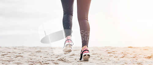 Image of Fitness, legs and feet running on beach sand for exercise, sports athlete or energy with mockup space from the back. Banner, closeup or shoes of runner at ocean for cardio workout, training or action