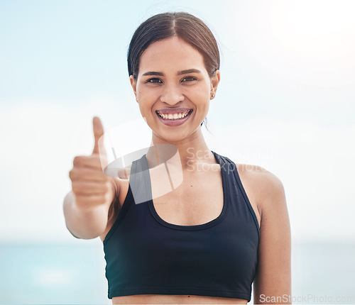 Image of Woman portrait, fitness and thumbs up at a beach with thank you, support or motivation sign in nature. Happy, face and lady runner with well done emoji for sea exercise, training or workout feedback