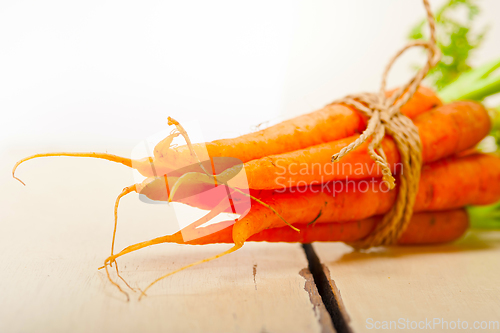 Image of baby carrots bunch tied with rope