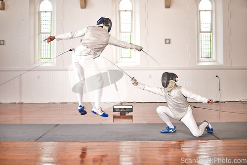 Image of Fencing, sport and jump with sword to fight in training, exercise or workout in a hall. Martial arts, match and fencers or people with mask and costume for fitness, competition or target in swordplay