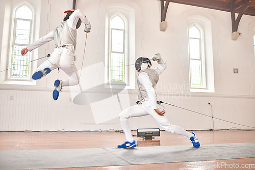 Image of Fencing, jump and sport with sword to fight in training, exercise or workout in a hall. Martial arts, stab and fencers or people with mask and costume for fitness, competition or target in swordplay