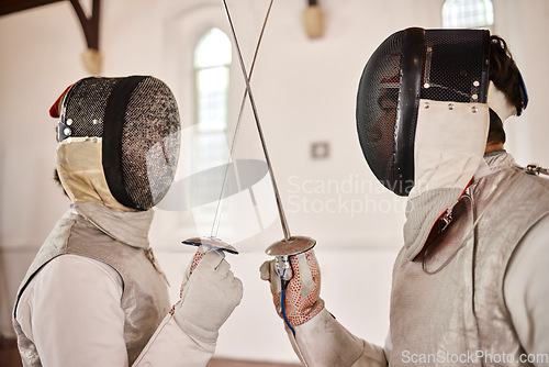 Image of Fencing, sport and start fight with sword in training, exercise or challenge in hall. Martial arts, crossed and fencers or people with mask and costume for fitness, competition or target in swordplay