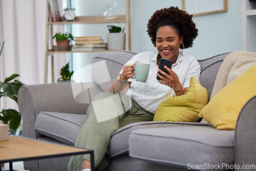 Image of Woman, coffee and smartphone on sofa in living room, social media and reading funny memes. Happy female person relax on couch, cellphone and tea for texting, chat app and download mobile games