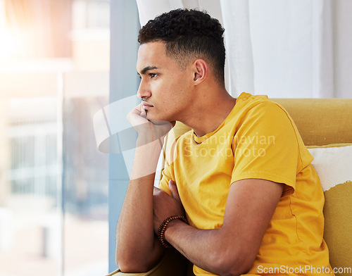 Image of Thinking, man and home sofa with depression and problem in living room feeling bored and frustrated. Sad, grief and mental health of a male person on couch with anxiety and tired from stress of fail