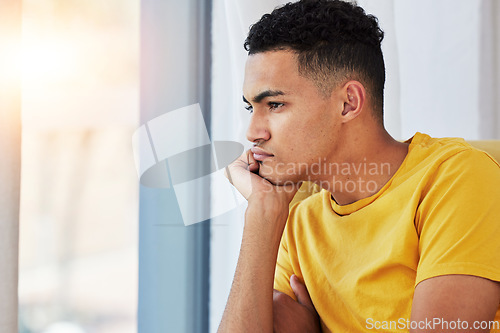 Image of Thinking, man and home with stress and sad in living room feeling bored and frustrated. Moody, grief and mental health of a male person on a couch with anxiety and tired from concerns of fail