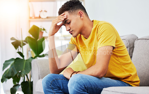 Image of Tired, stress and student with man on sofa for pain, burnout and headache. Fatigue, mental health and frustrated with male person thinking in living room at home for anxiety, exhausted and migraine