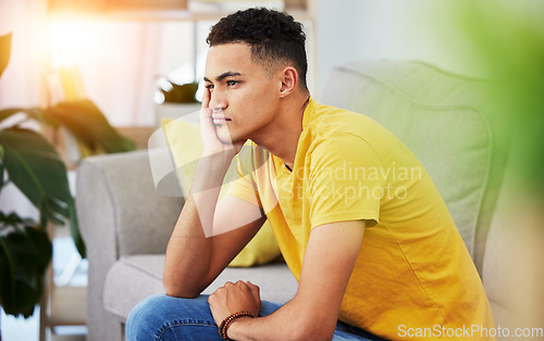 Image of Thinking, man and home sofa with stress and depression in living room feeling bored and frustrated. Sad, grief and mental health of male person on a couch with anxiety and tired from concerns of fail