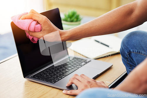 Image of Hygiene, laptop and closeup of man cleaning his screen to prevent dust, dirt or germs at his desk. Technology, health and male person wipe computer with a cloth for sanitizing or disinfection at home