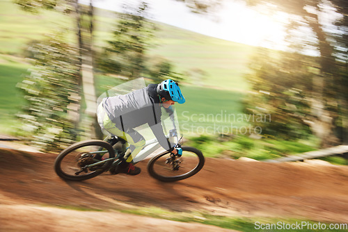 Image of Mountain bike, man and motion blur in forest for competition, speed or off road adventure on path. Fast athlete, sports and bicycle for contest, cardio race and power in nature, park or action trail