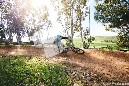 Image of Mountain bike, man and cycling in forest for competition, freedom and off road adventure on path. Athlete, extreme sports and bicycle for action, cardio race and adrenaline in nature, park and trail