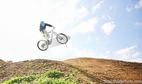 Image of Mountain bike, man and jump in sky for competition, freedom and off road adventure. Athlete, extreme sports and bicycle in air for action, cardio race and stunt power in nature, path and mockup space