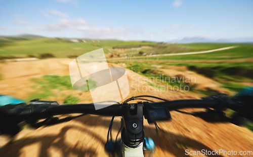 Image of Cycling, sports and person with bars on bicycle for adrenaline on adventure, freedom and speed. Mountain bike, fast blur and cyclist for training, exercise and fitness on dirt road, trail or track