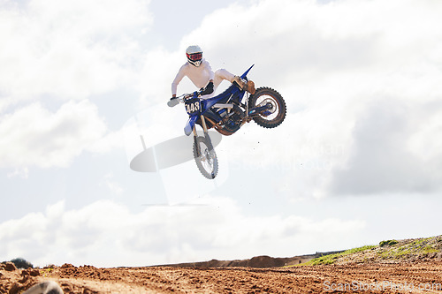 Image of Sports, jump and man on motorcycle with freedom, energy and power stunt in the countryside for training challenge. Off road, air and male jumping with motorbike for speed, performance or Moto action