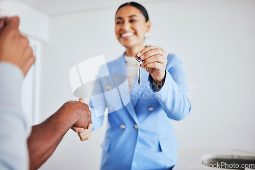 Image of Moving in, house keys and female realtor shaking hands for congratulations with homeowner clients. Happy, real estate and young woman agent doing a professional agreement handshake with people.