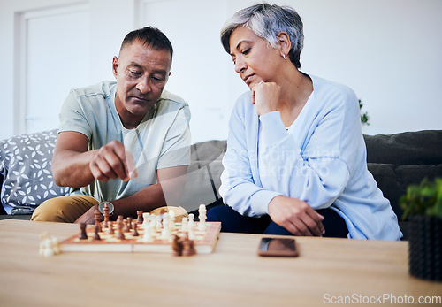 Image of Senior couple, chess match and home with thinking, strategy and mindset for brain power, relax and bonding. Elderly woman, man and sofa with board game, ideas and brainstorming for challenge in house